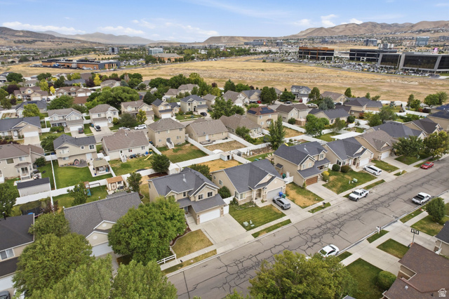 2223 North Pointe Meadow Loop Lehi, UT 84048 - Photo 50 of 56 Residential streetscape featuring numerous single-family homes with pitched roofs and attached garages