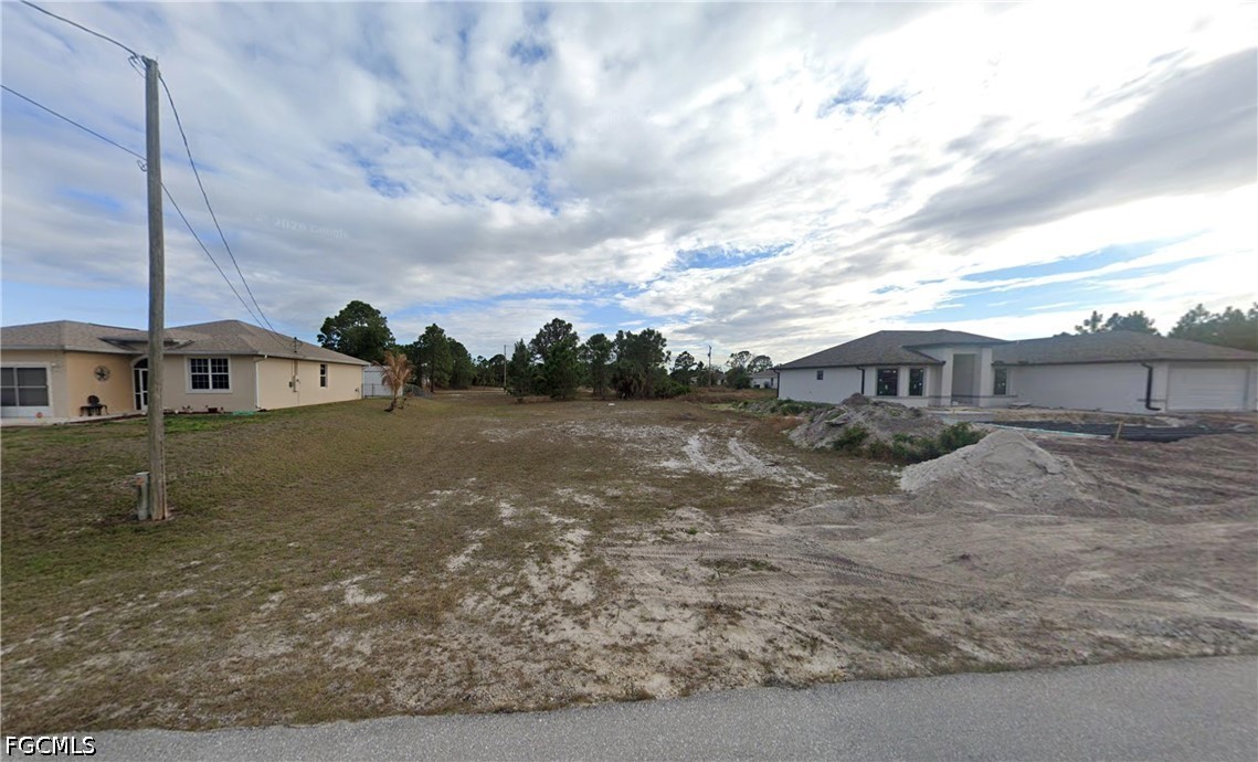3503 26th Street Southwest Lehigh Acres, FL 33976 - Photo 1 of 9 a view of a house with a yard