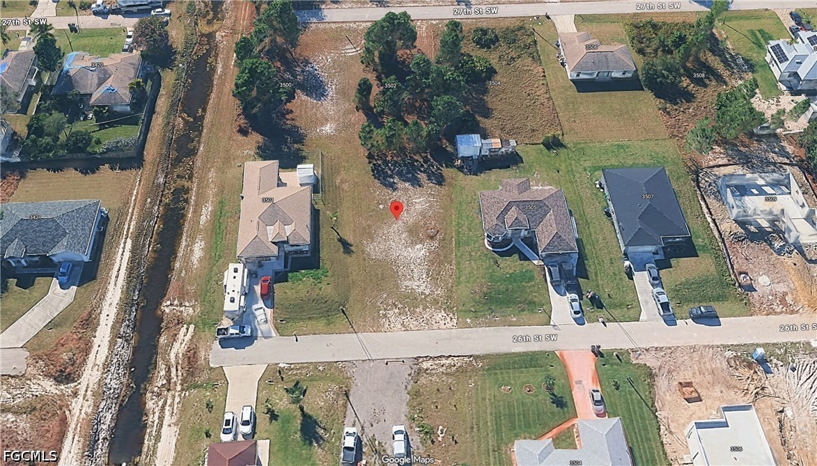 3503 26th Street Southwest Lehigh Acres, FL 33976 - Photo 4 of 9 an aerial view of a house with a yard