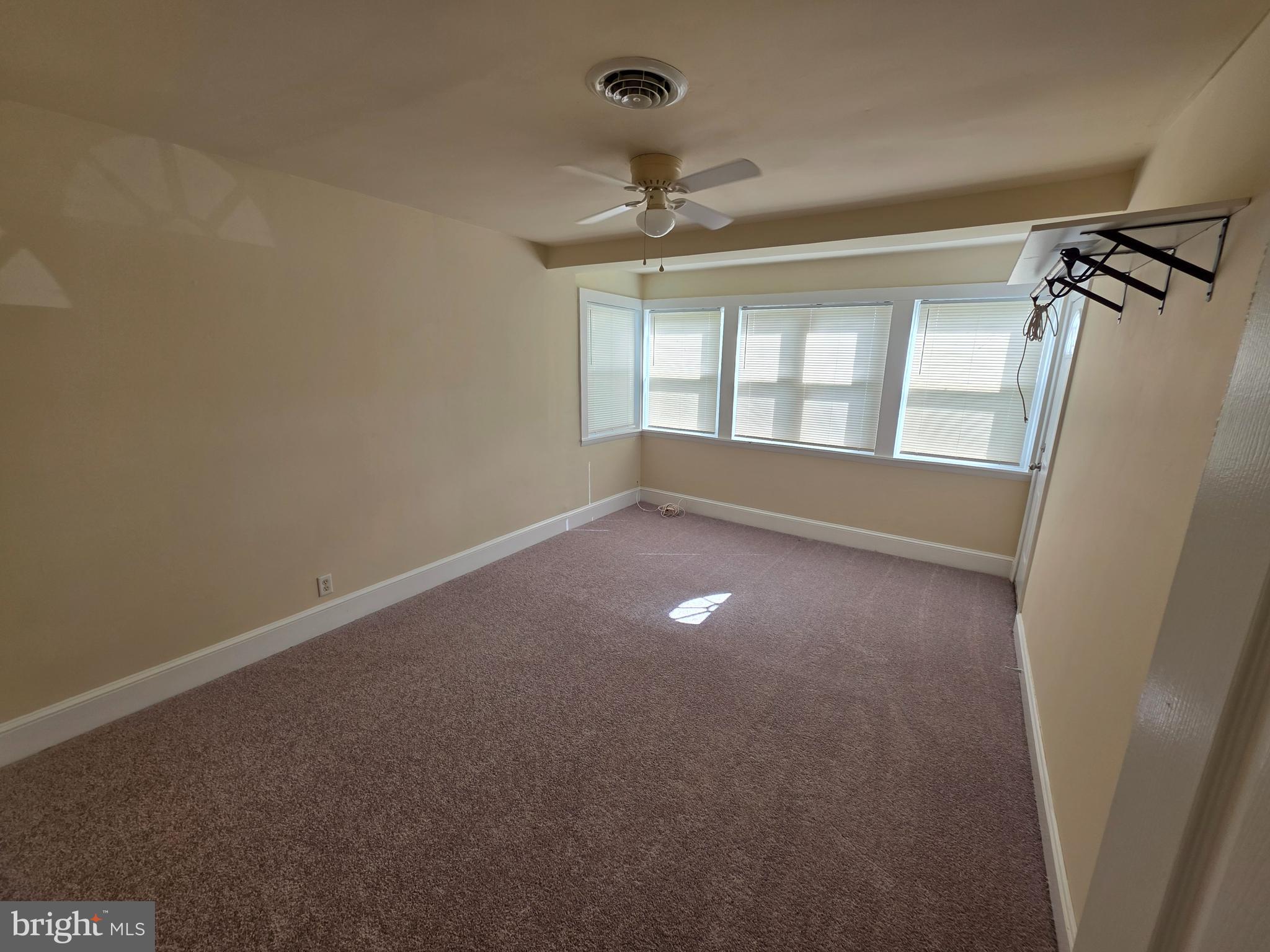 2318 Forrest Avenue Dover, DE 19904 - Photo 6 of 12 an empty room with windows and entrance