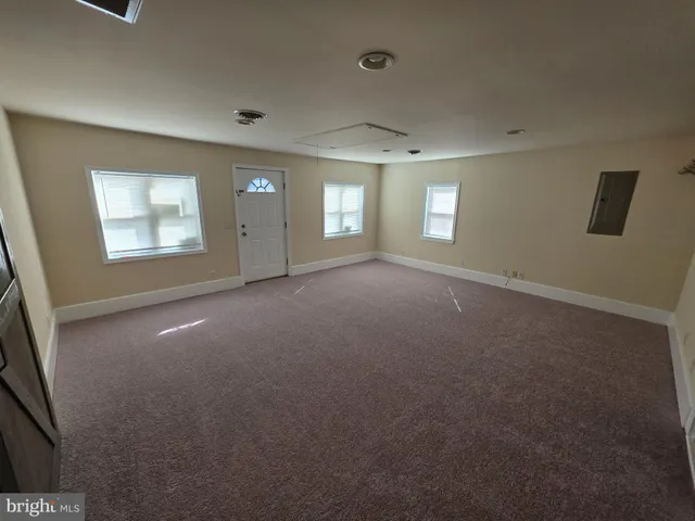 a bathroom with a granite countertop sink toilet and mirror