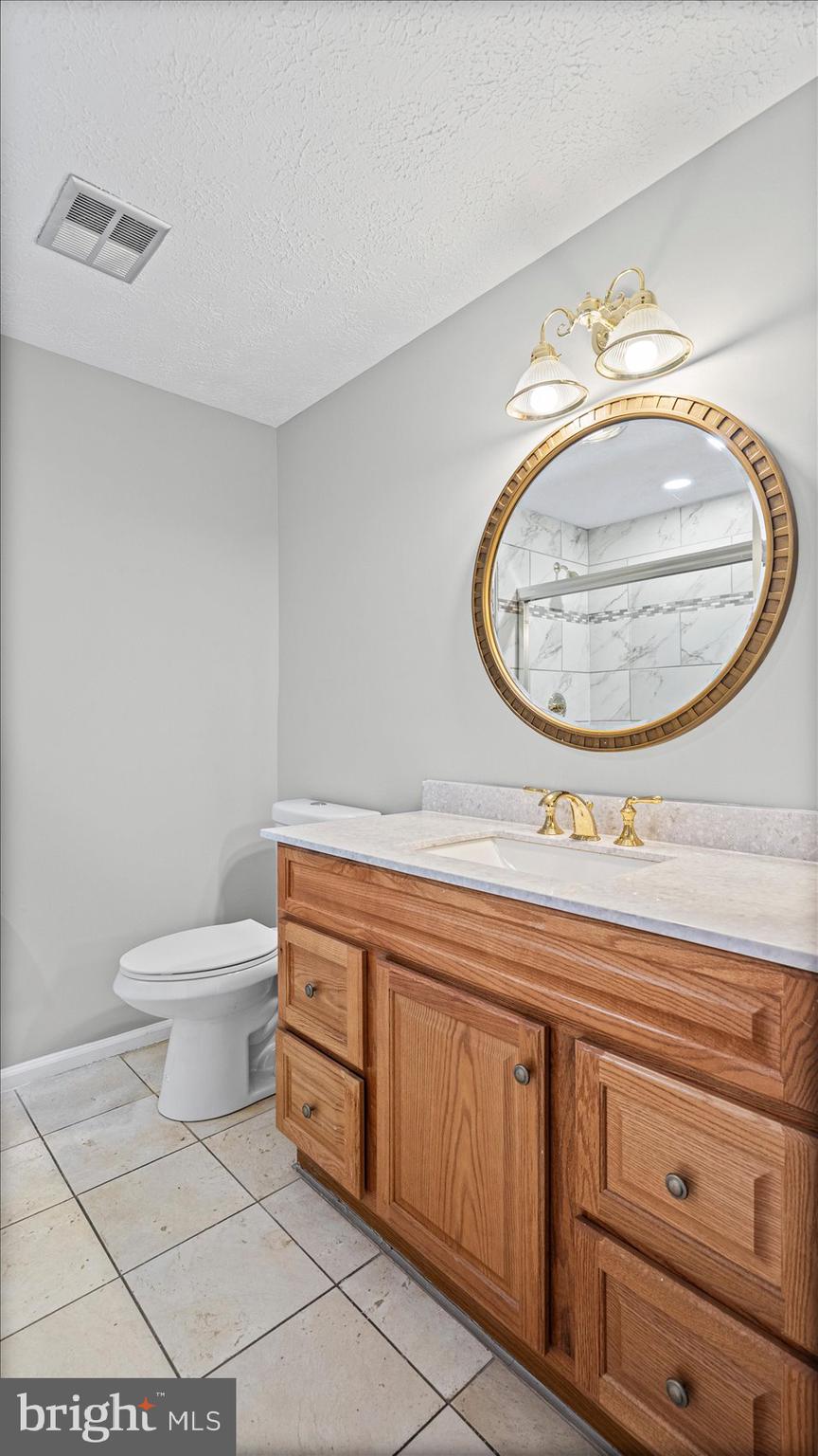 3709 Redberry Way Nottingham, MD 21236 - Photo 30 of 45 a bathroom with a toilet a sink and a mirror