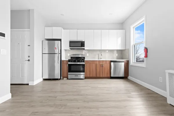 a kitchen with stainless steel appliances a refrigerator sink and microwave