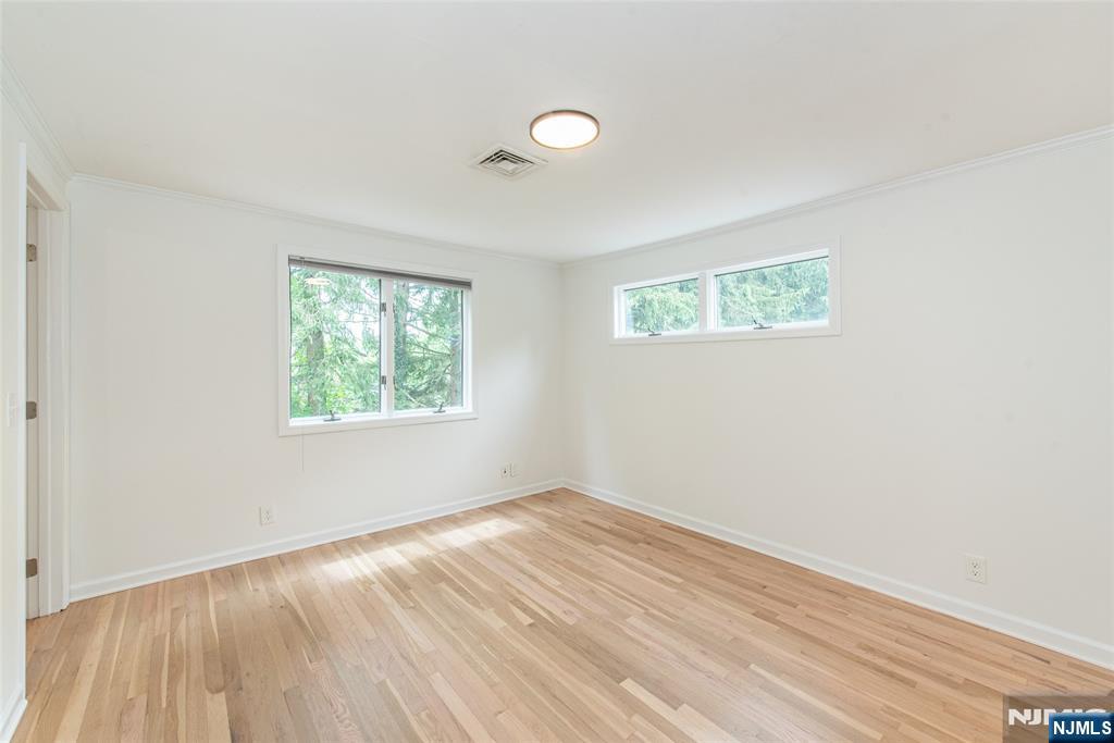 163 Sand Spring Road Morristown, NJ 07960 - Photo 22 of 39 an empty room with wooden floor and windows