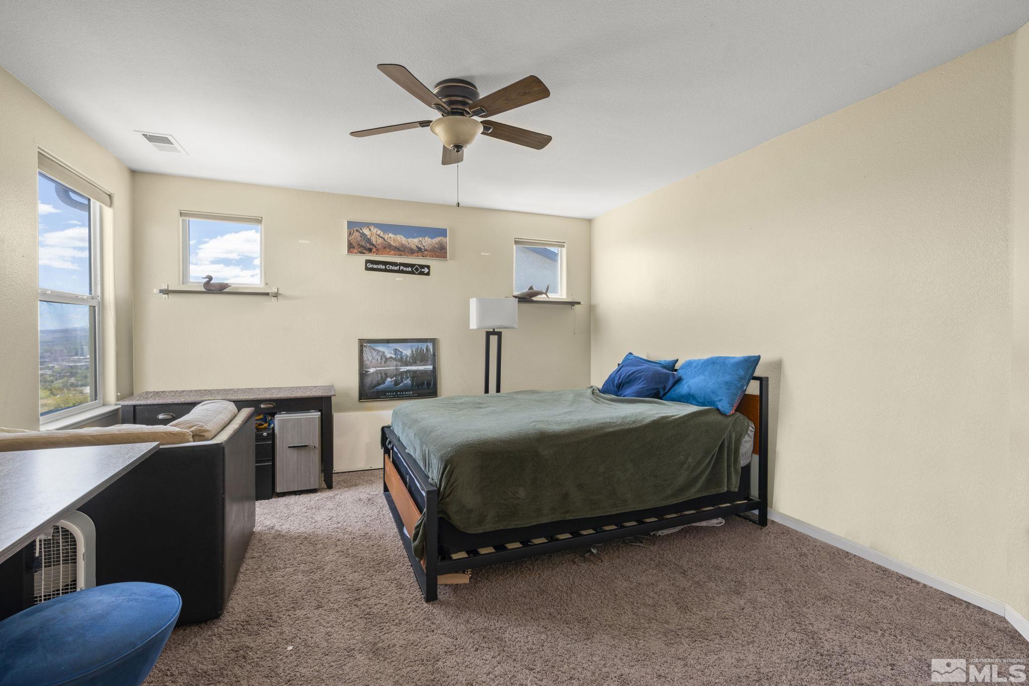 1010 South University Park Loop Reno, NV 89512 - Photo 8 of 16 a bed room with a bed and a desk