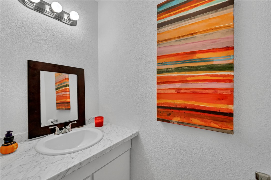 2056 Hidden Lake Corpus Christi, TX 78412 - Photo 13 of 26 a bathroom with a sink and a mirror