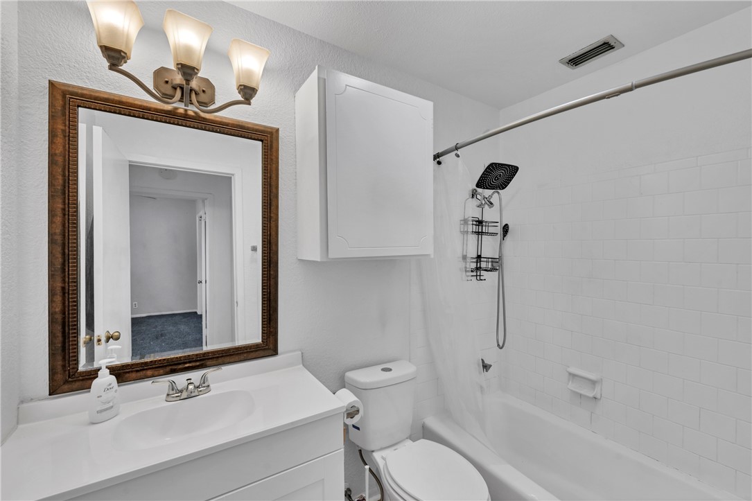 2056 Hidden Lake Corpus Christi, TX 78412 - Photo 18 of 26 a bathroom with a sink a toilet and shower