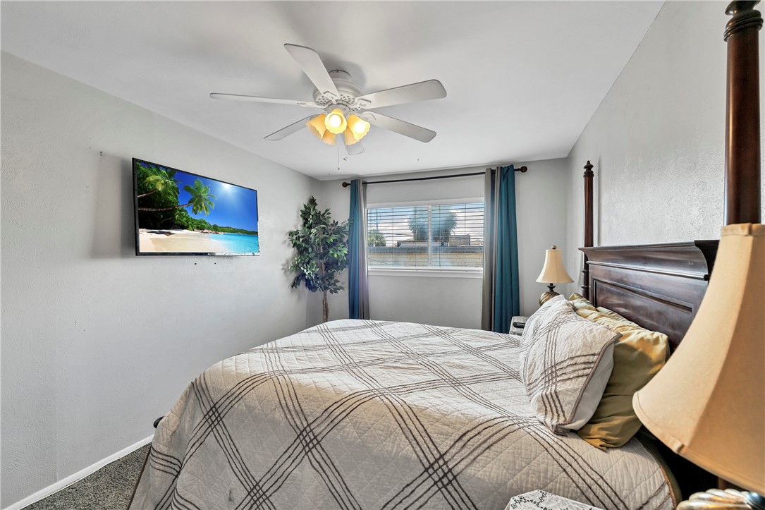 2056 Hidden Lake Corpus Christi, TX 78412 - Photo 19 of 26 a bedroom with a bed a painting on the wall and a potted plant