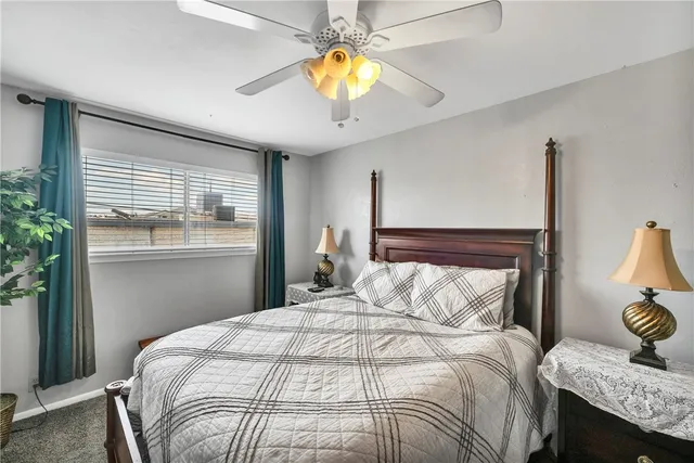 a bedroom with a bed and painting on the wall