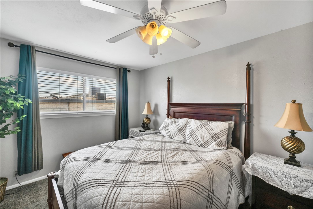 2056 Hidden Lake Corpus Christi, TX 78412 - Photo 20 of 26 a bedroom with a bed and a chandelier