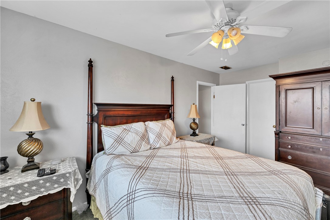 2056 Hidden Lake Corpus Christi, TX 78412 - Photo 21 of 26 a bedroom with a bed and painting on the wall
