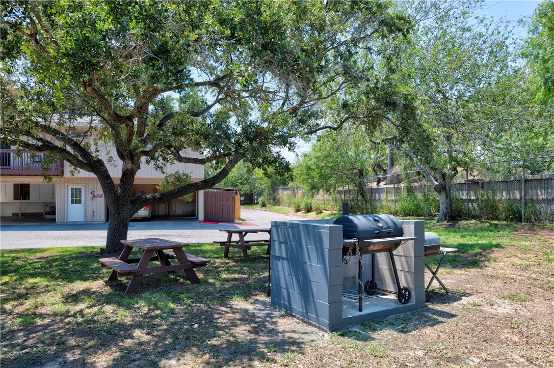2056 Hidden Lake Corpus Christi, TX 78412 - Photo 26 of 26 a view of a backyard with wooden fence and a large tree