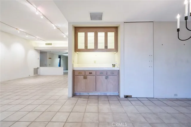 a kitchen with granite countertop white cabinets stainless steel appliances a sink and a window
