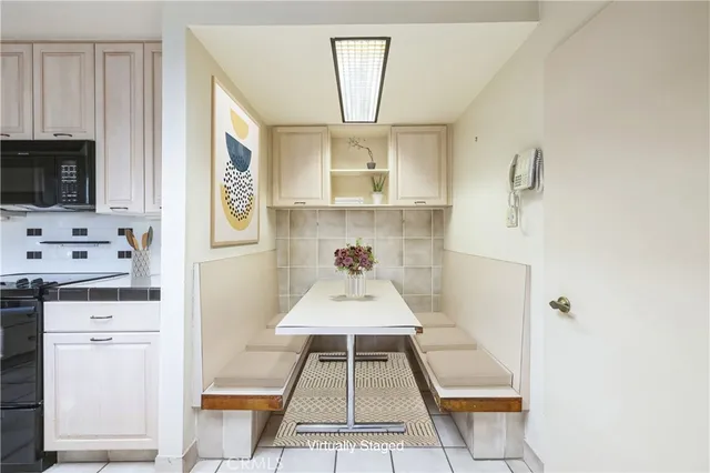a kitchen with granite countertop white cabinets and stainless steel appliances