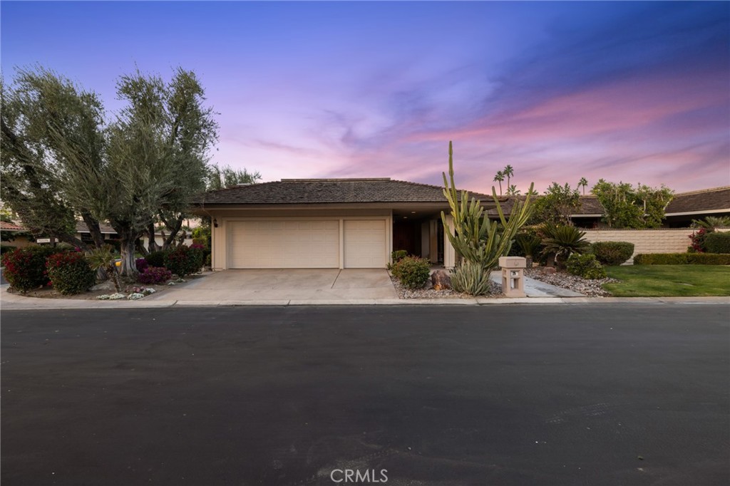 1 Radcliff Court Rancho Mirage, CA 92270 - Photo 2 of 52 a front view of a house with a yard and garage