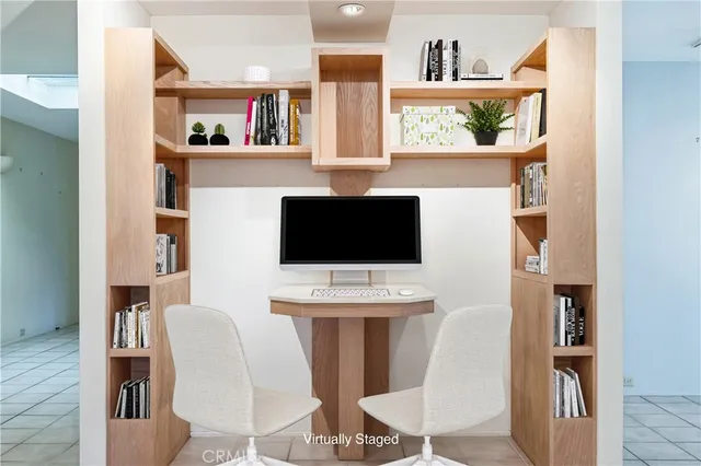 an empty room with a fireplace and chandelier