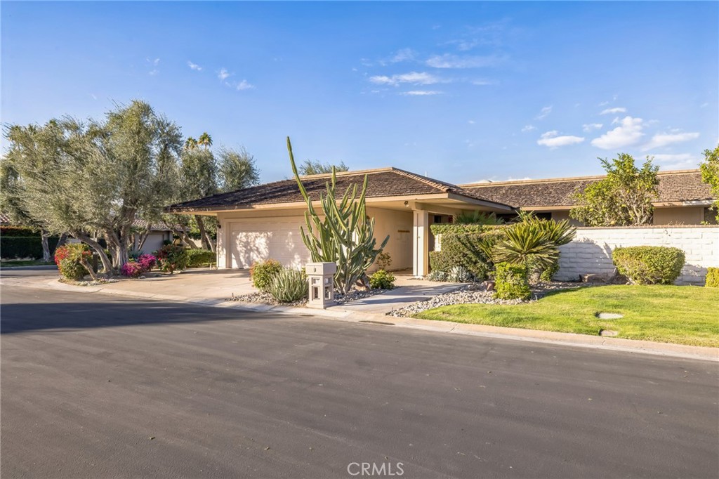 1 Radcliff Court Rancho Mirage, CA 92270 - Photo 3 of 52 a front view of a house with a garden