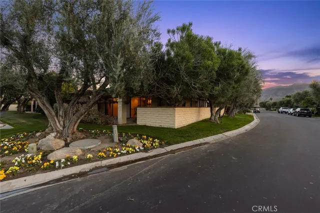 a view of a house with a yard and a car park