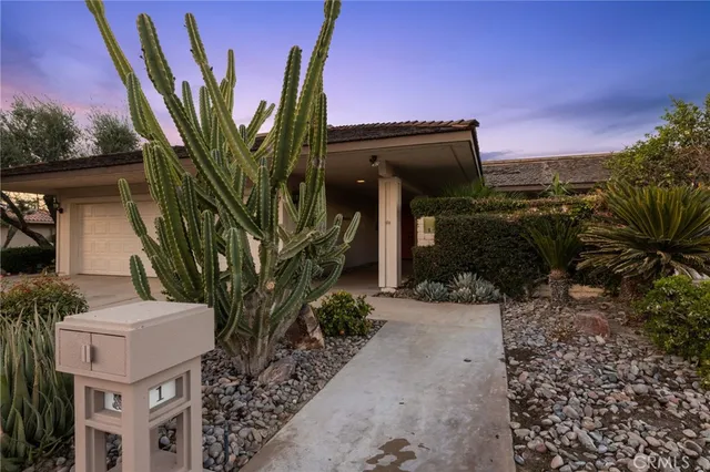 a view of a house with a tree in the background