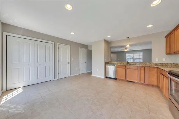 a large white kitchen with a sink and cabinets