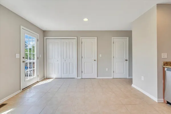 a view of room with hardwood floor and entryway