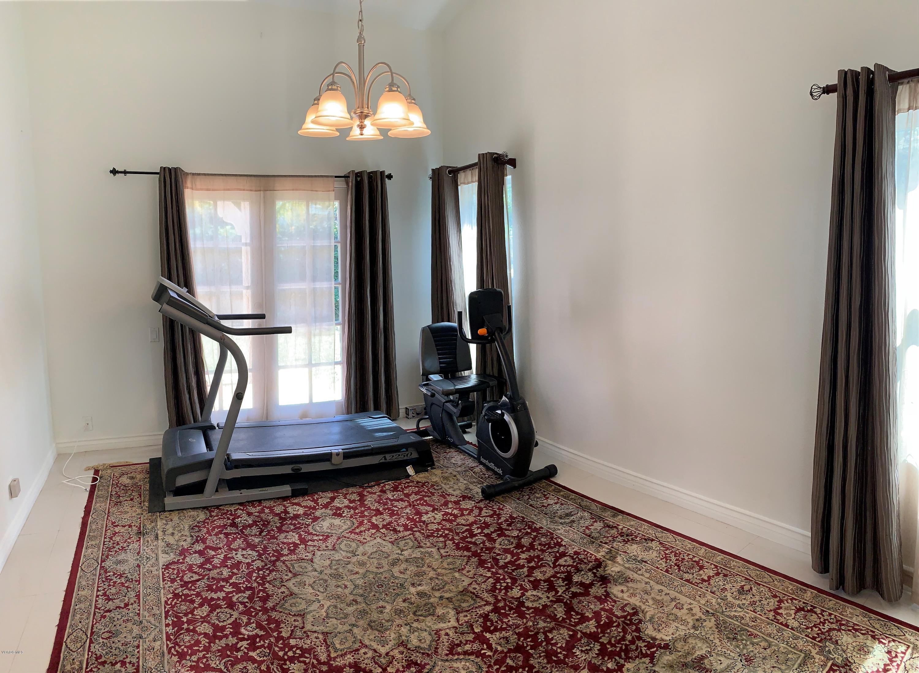 12448 Spring Creek Road Moorpark, CA 93021 - Photo 16 of 19 a room with gym equipment and a mirror