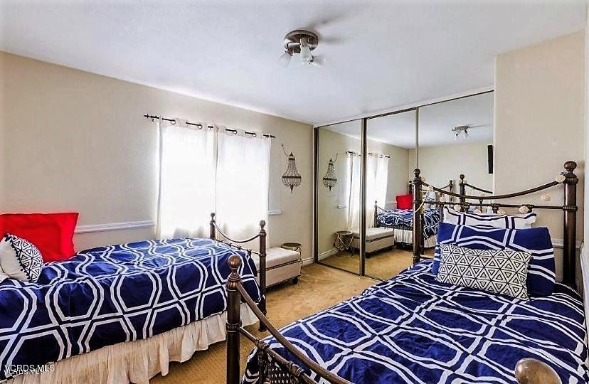 12448 Spring Creek Road Moorpark, CA 93021 - Photo 17 of 19 a bedroom with a bed and wooden floor