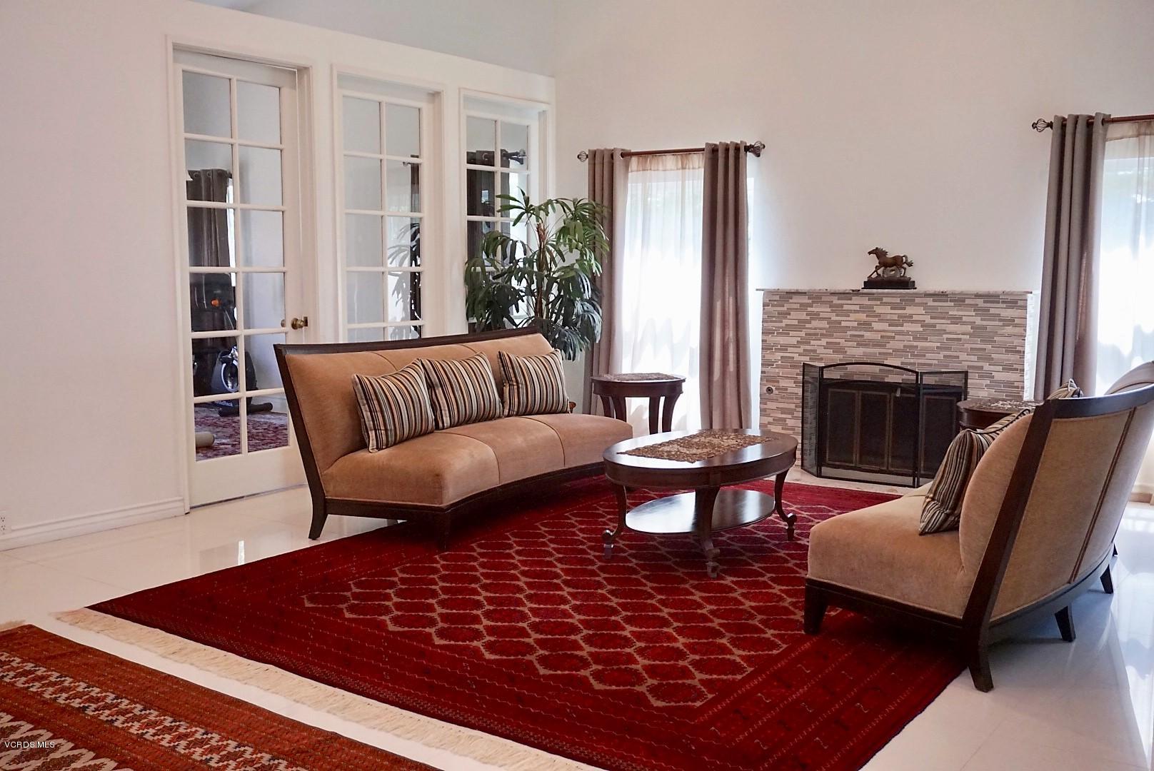 12448 Spring Creek Road Moorpark, CA 93021 - Photo 3 of 19 a living room with furniture and a fireplace