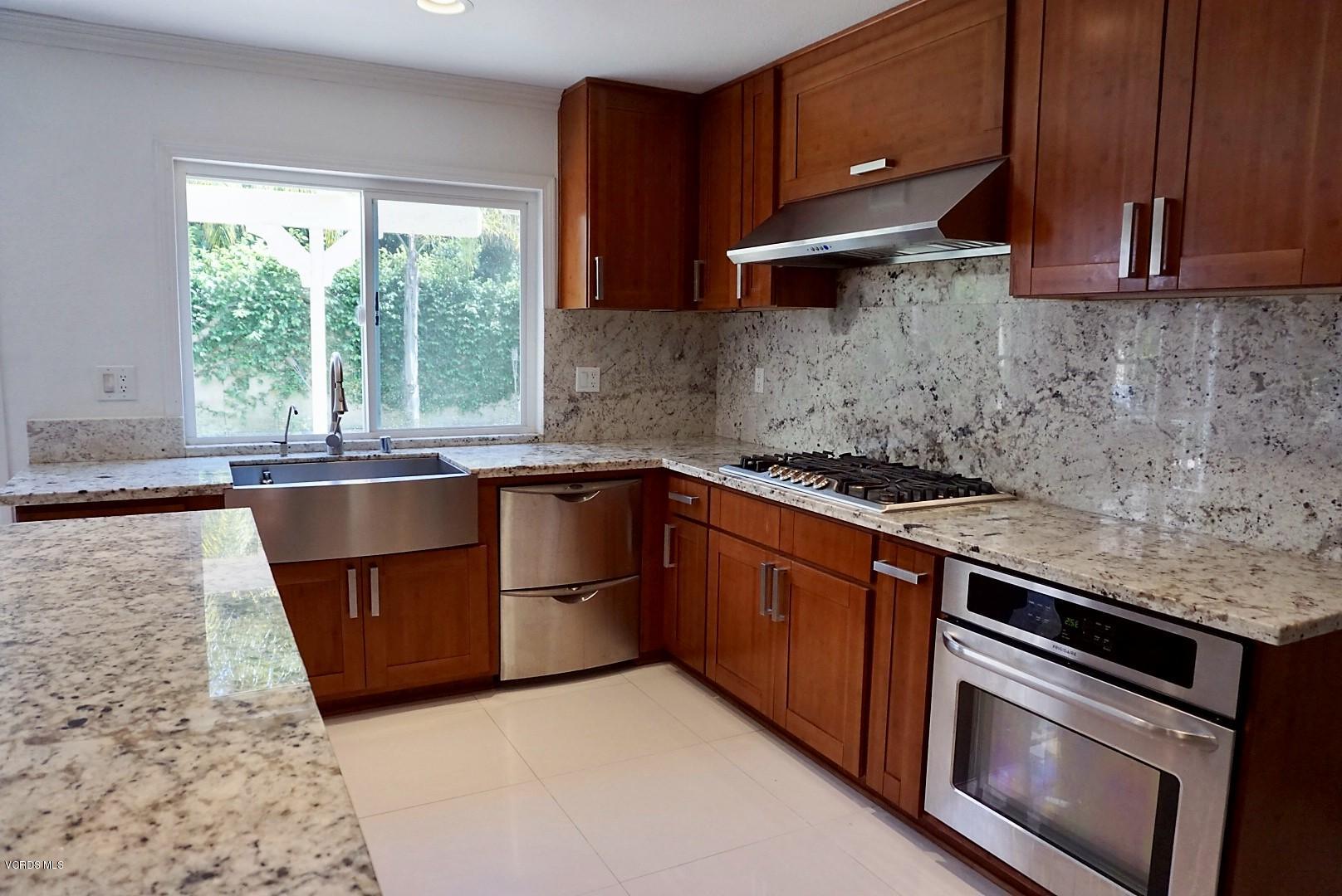 12448 Spring Creek Road Moorpark, CA 93021 - Photo 6 of 19 a kitchen with stainless steel appliances granite countertop a sink stove and microwave
