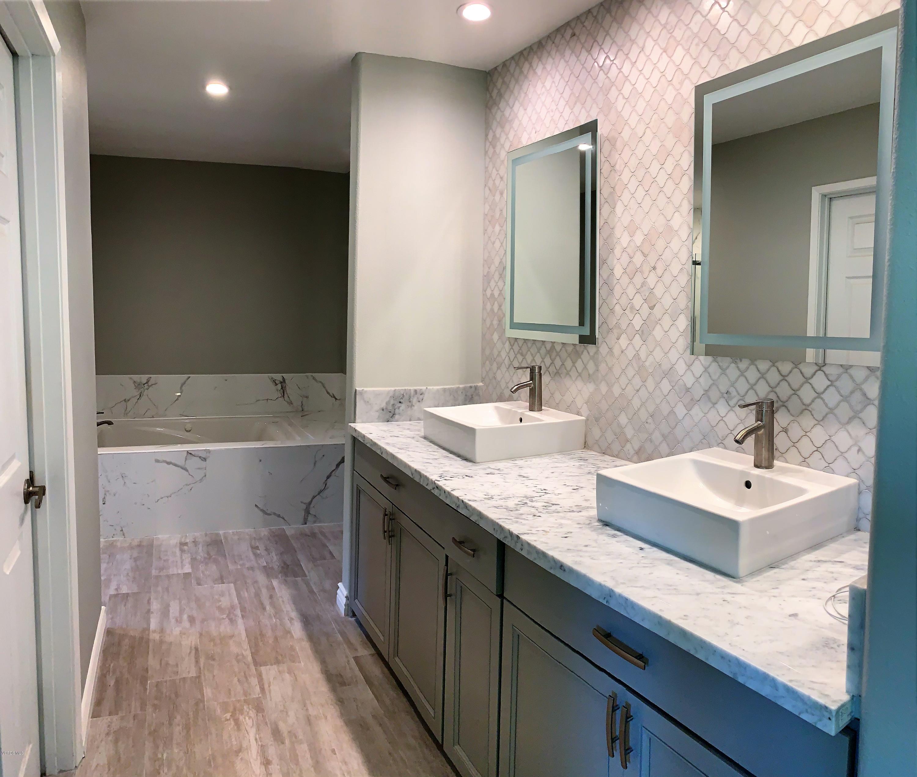 12448 Spring Creek Road Moorpark, CA 93021 - Photo 8 of 19 a bathroom with a sink double vanity granite and a bathtub