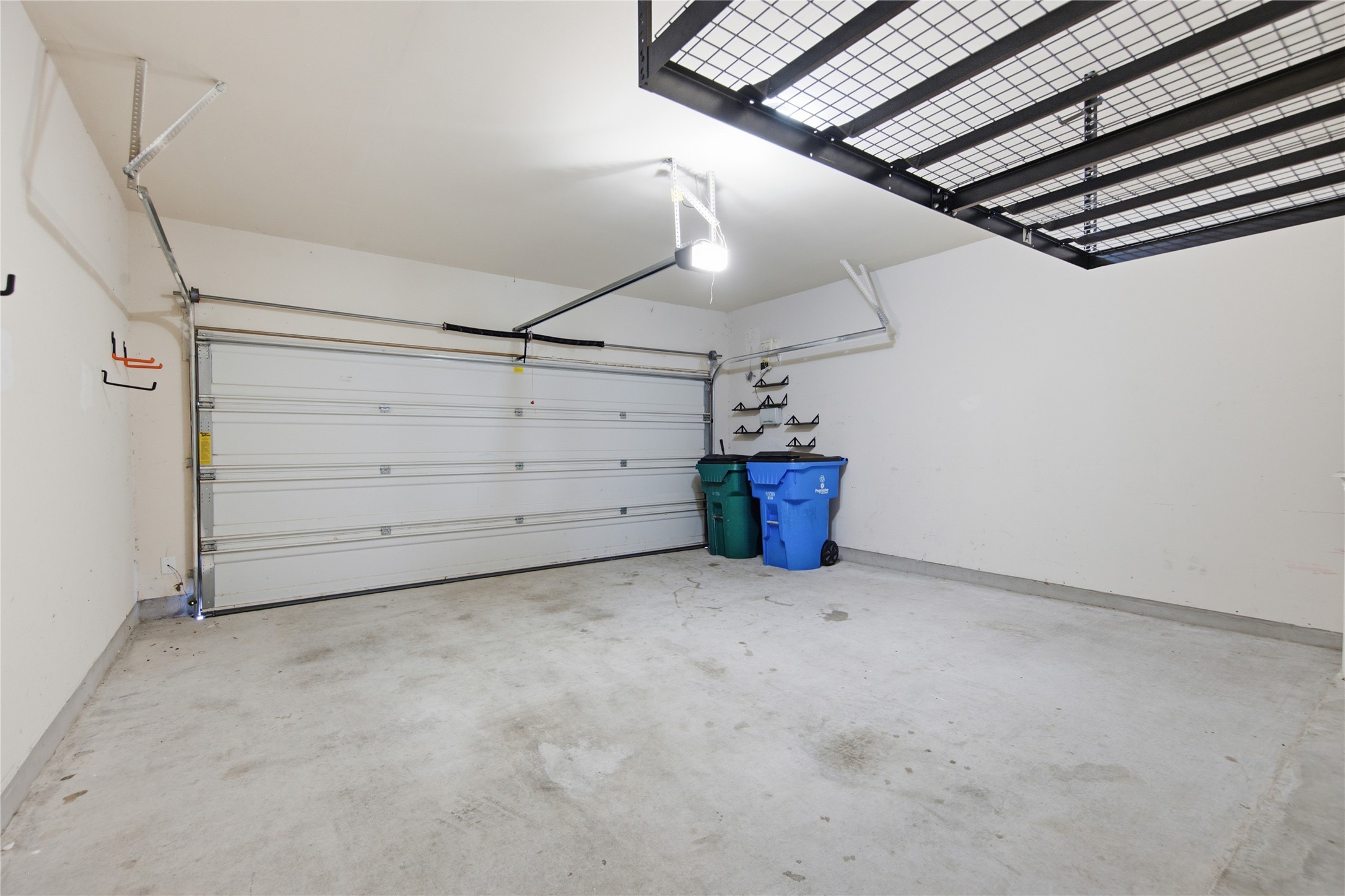 2601 Rough Berry Road Pflugerville, TX 78660 - Photo 30 of 36 A spacious, clean garage features an overhead door and convenient elevated storage racks.
