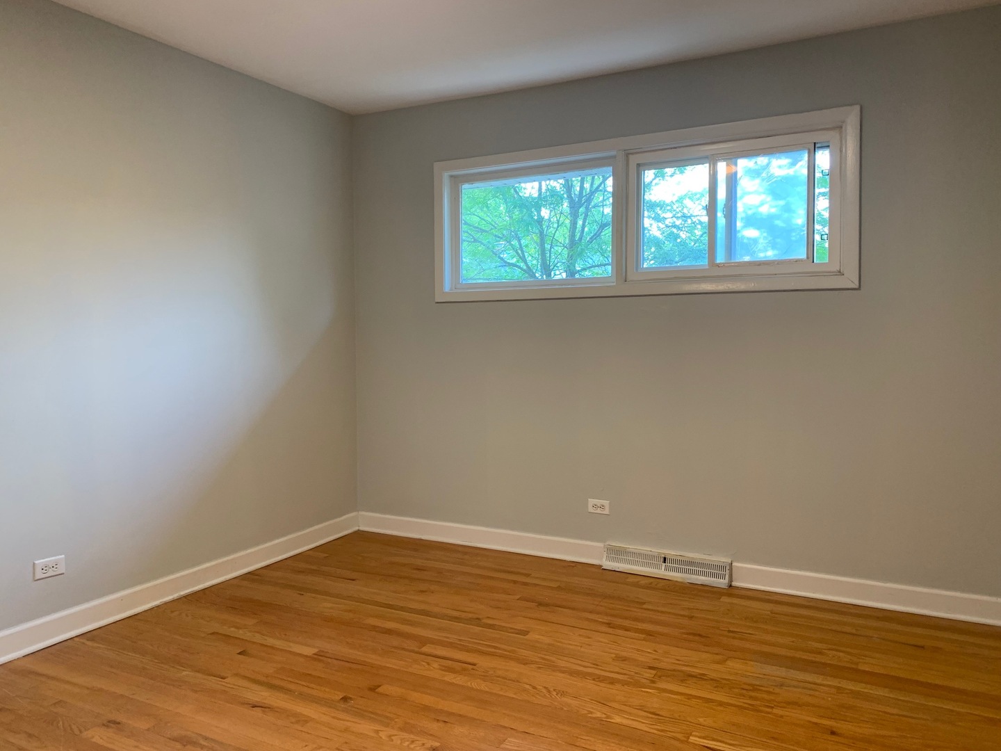 811 Hibbard Road, Unit C Wilmette, IL 60091 - Photo 14 of 19 an empty room with wooden floor and windows