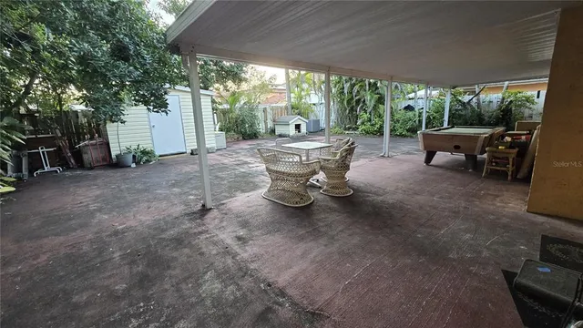 a view of a patio with table and chairs and potted plants