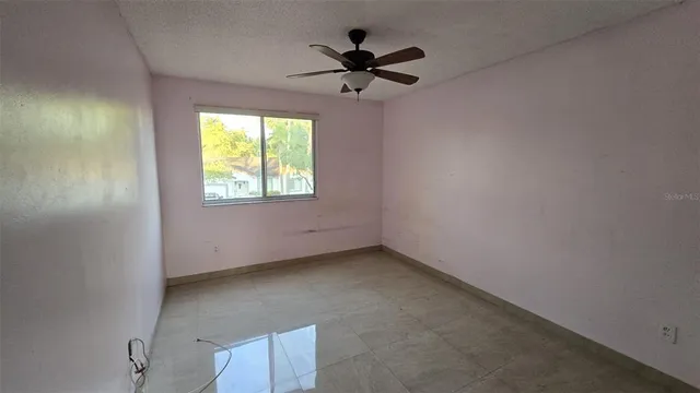 a kitchen with granite countertop a sink a stove and cabinets