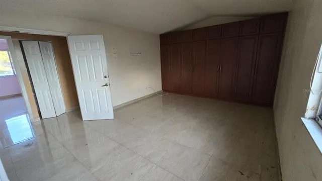 a kitchen with granite countertop a sink a counter top space and cabinets
