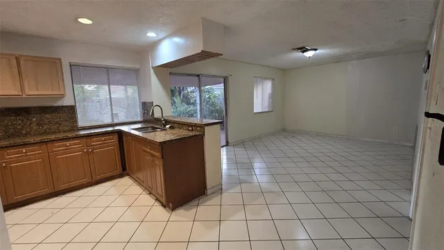 a kitchen with granite countertop white cabinets and stainless steel appliances