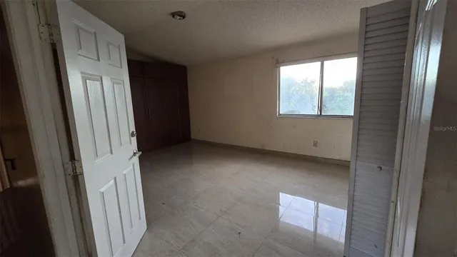 a view of an empty room with a window