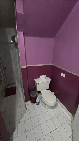 a white toilet sitting next to a shower