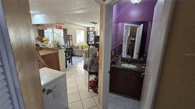 a kitchen with refrigerator and cabinets