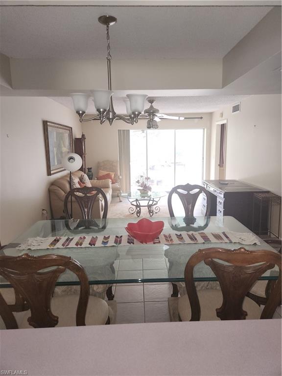30 Watercolor Way, Unit 30 Naples, FL 34113 - Photo 2 of 9 Dining area with a chandelier