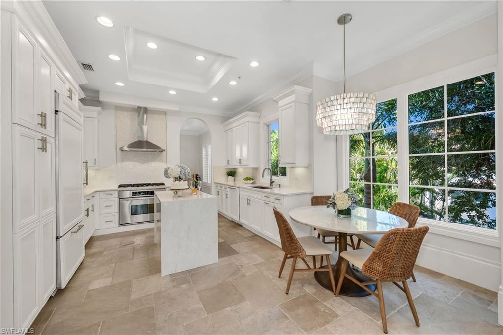 2323 Tradition Way, Unit 201 Naples, FL 34105 - Photo 3 of 48 Updated kitchen with quartz waterfall island, counters, new backsplash, new stainless hood...such a great kitchen to whip up your favorite meals!