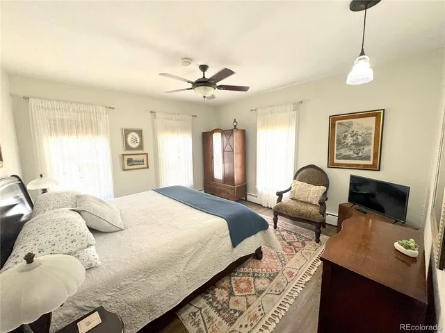 a bedroom with a bed and a large window