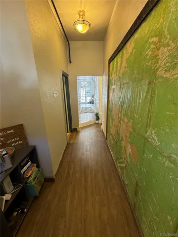 a view of a hallway with wooden floor