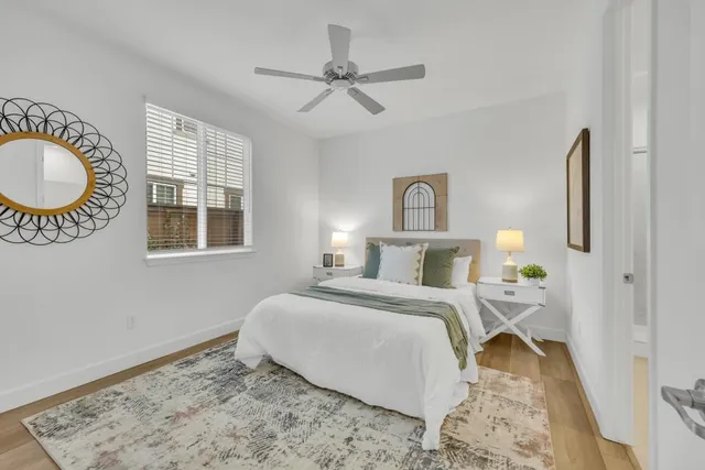 a view of a livingroom with furniture and a chandelier fan