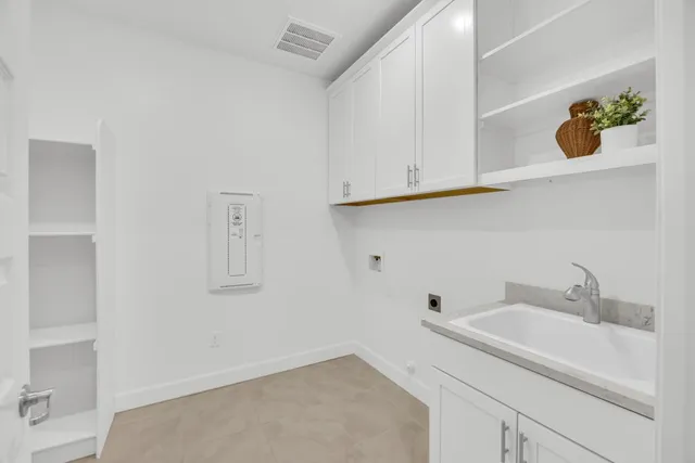 a kitchen with kitchen island granite countertop wooden cabinets and white appliances