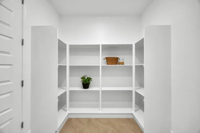 a kitchen with counter top space a sink wooden floor and stainless steel appliances
