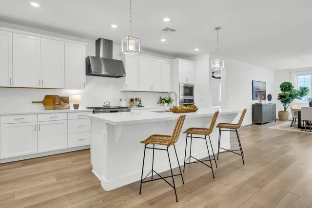 a bedroom with a bed a flat screen tv and a couch