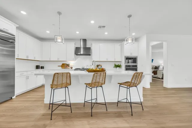 a spacious bathroom with a granite countertop tub sink and mirror