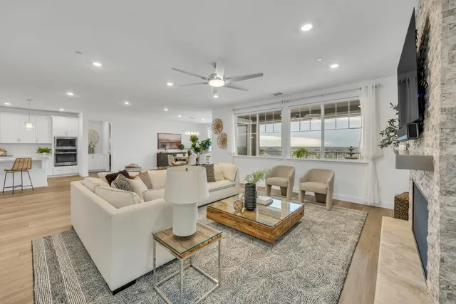 a view of a patio with dining table and chairs under an umbrella with a patio
