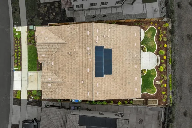 a view of a hallway with wooden floor and a kitchen